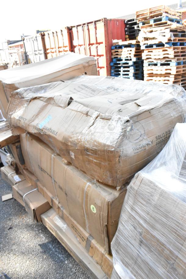 Fifteen brand new boxes with visible labels including Regency dirty dish table and wire shelf, displayed on pallets.