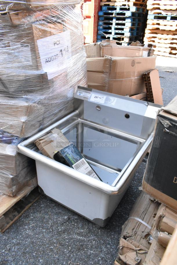 Brand new Steelton 522CS11818N stainless steel single bay sink with visible scratches and dents, boxed in warehouse setting.