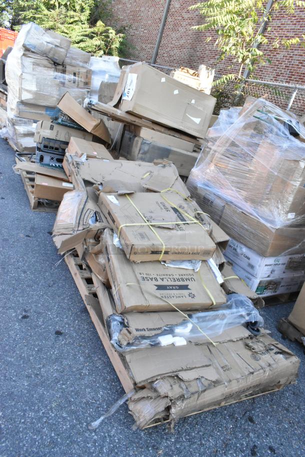 Pallet with six brand new boxes, including umbrella bases and work tables. Boxes show some wear from shipping.