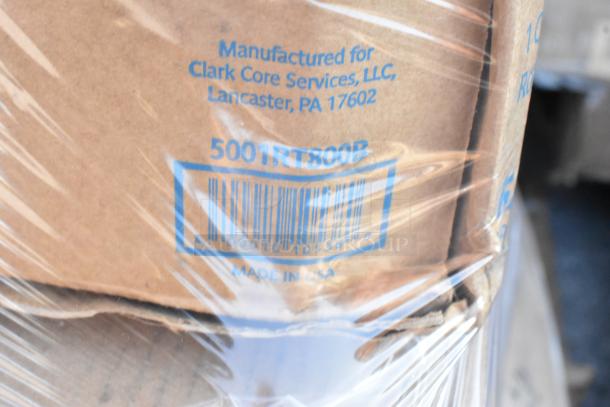 Stacked boxes wrapped in plastic, labeled "Manufactured for Clark Core Services, LLC, Lancaster, PA 17602."
