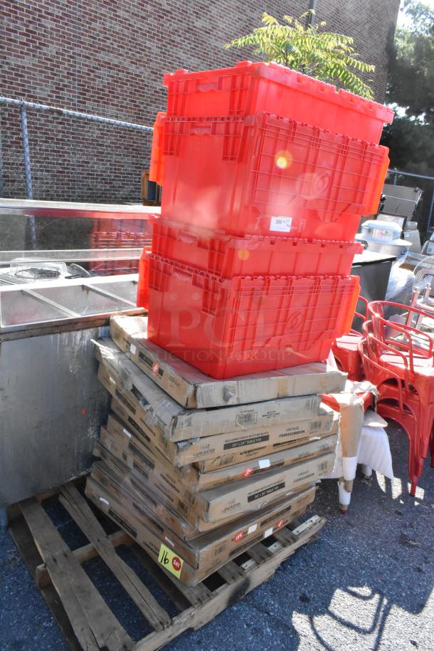 Stack of new red plastic crates and boxed items on a wooden pallet, marked "Lancaster" and "Reclaimed Wood" for auction.