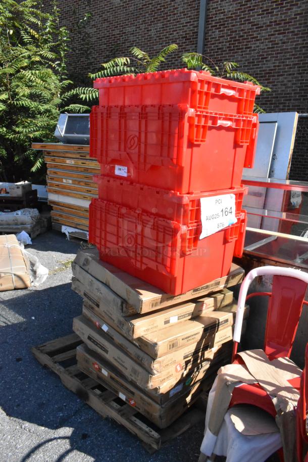 Stacked red containers labeled "PCI AUG25-164" atop boxed furniture items like tables and shelves, on a wooden pallet.