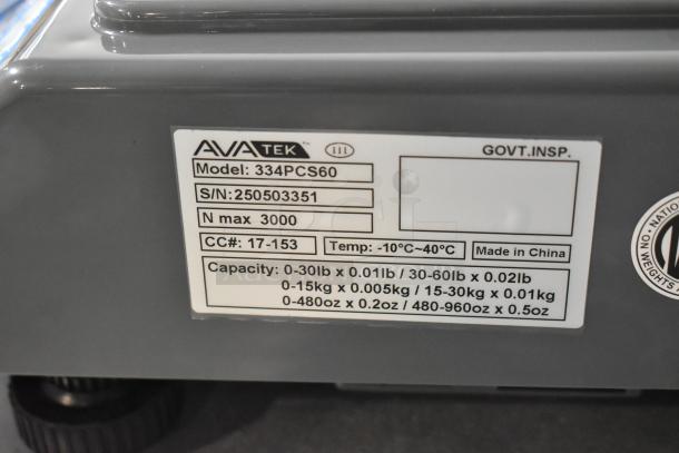 Brand new AvaTek 334PCS60, 60 lb digital price computing scale. Model 2025, capacities and serial label visible. Deluxe condition.
