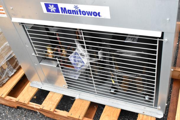 Brand new Manitowoc remote compressor for ice head, visible scratch and dent, on pallet, model details on label.