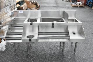 Brand new Regency 60" stainless steel cocktail station, minor scratches, includes liquor display rack and cold plate.