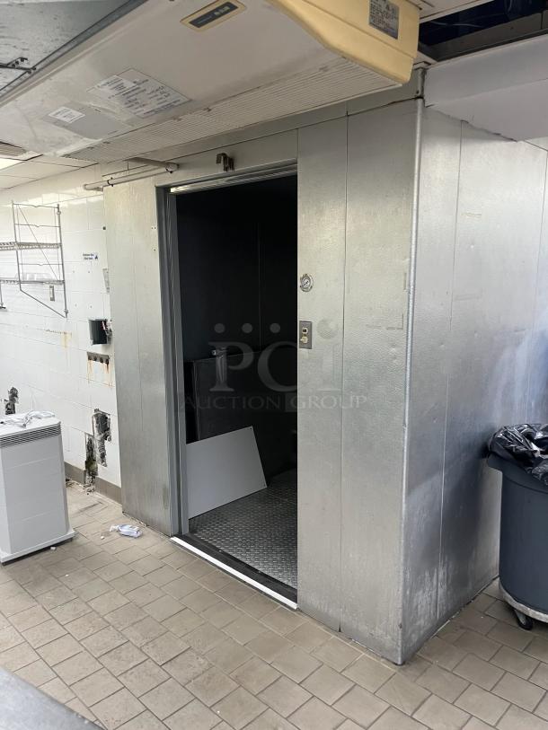 8'x12' Harford walk-in freezer box with Bohn 115V, 1 phase evaporator fan, metallic exterior, open door.