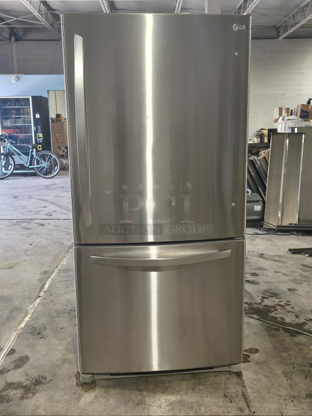 LG 22.4 cu ft stainless steel refrigerator with single door, pull-out bottom freezer. Clean condition, visible LG logo.