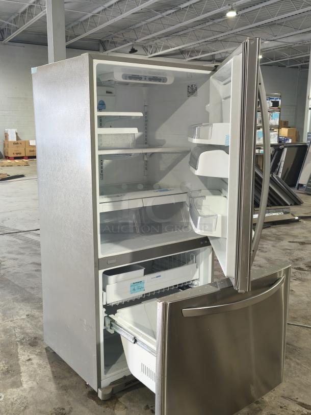 LG 22.4 Cu. Ft. Single Door Refrigerator with Pull-out Bottom Freezer. Stainless steel. Interior shelves and bins. Open doors.