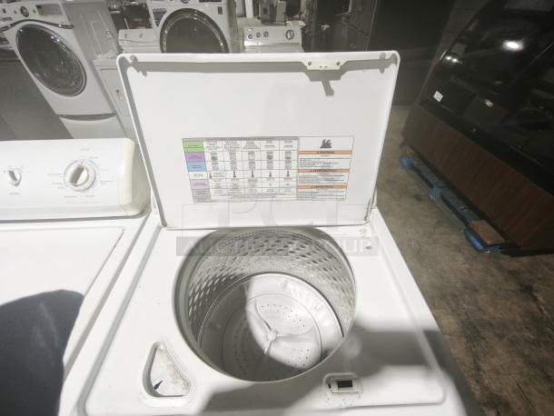 Whirlpool 4.3 cu.ft top load washer, model WTW5000DW. Features 12 cycles, Quick Wash. Lid open, control panel visible.
