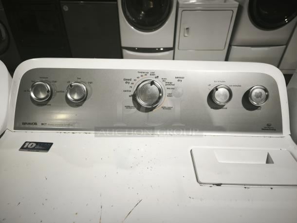 MAYTAG 7.0 cu. ft. Dryer MEDX655DW with sanitize cycle, control knobs shown. Features sensor drying, 10-year warranty label.