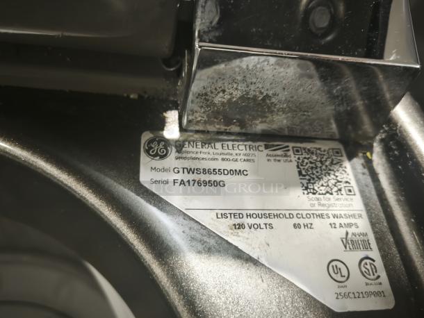 GE washer model GTWS8655D0MC label, indicating 5.0 cu. ft. capacity, stainless steel basket, steam feature, and 120 volts.