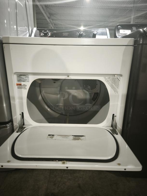 Whirlpool LA7680XSW2 top-load washer, white, control knobs on top panel, open door showing interior, labels visible.