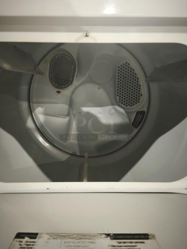 Whirlpool LA7680XSW2 top-load washer interior, showing drum and agitator. Good condition with visible filter screens.