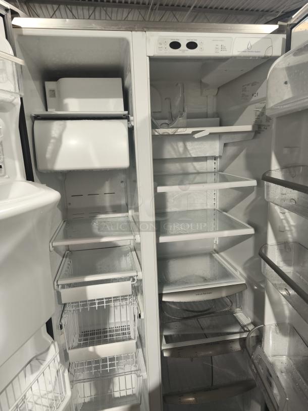 Frigidaire Gallery 22.6 Cu. Ft. side-by-side refrigerator, model PHSC39EESS. Features glass shelves and ample freezer space.