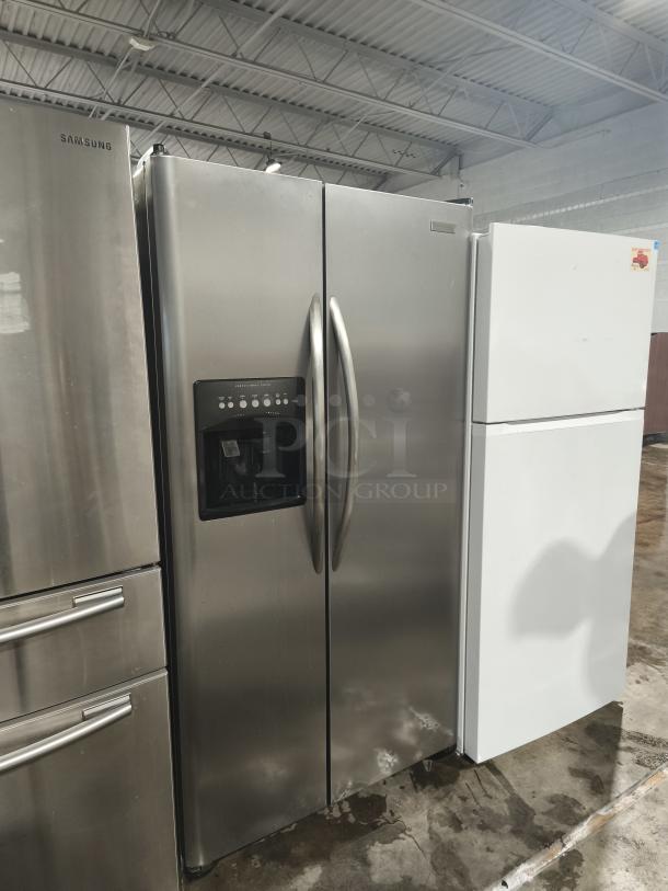 Frigidaire Gallery 22.6 Cu. Ft. Side-by-Side Refrigerator, model PHSC39EESS, stainless steel, with water dispenser.