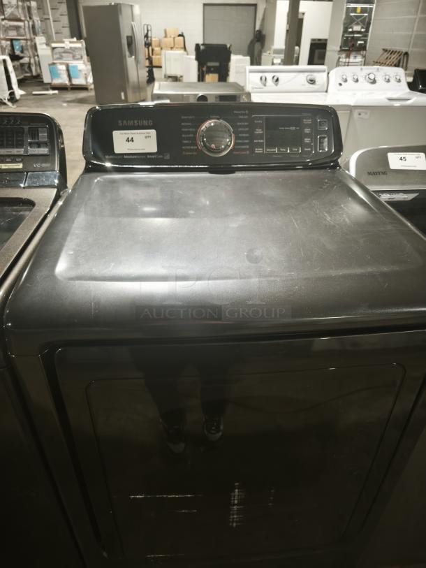 SAMSUNG 7.4 Cu. Ft. black stainless electric dryer with steam, model DVE52M7750V/A3, control panel visible, minor wear.