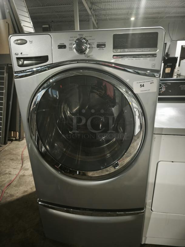 Whirlpool WFW94HEXL2 front-load washer, silver, digital controls, used condition, model tag visible.