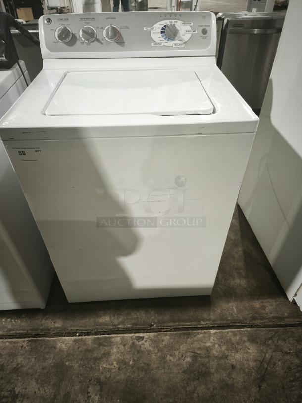 GE 4.1 cu. ft. top-load washer, model whre5550k2ww, white, with control dials and minor surface scratches.