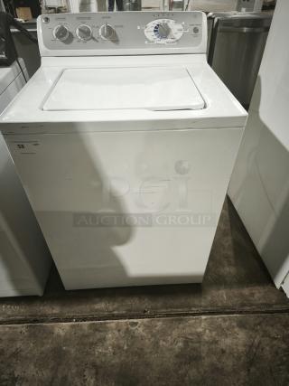 GE 4.1 cu. ft. top-load washer, model whre5550k2ww, white, with control dials and minor surface scratches.