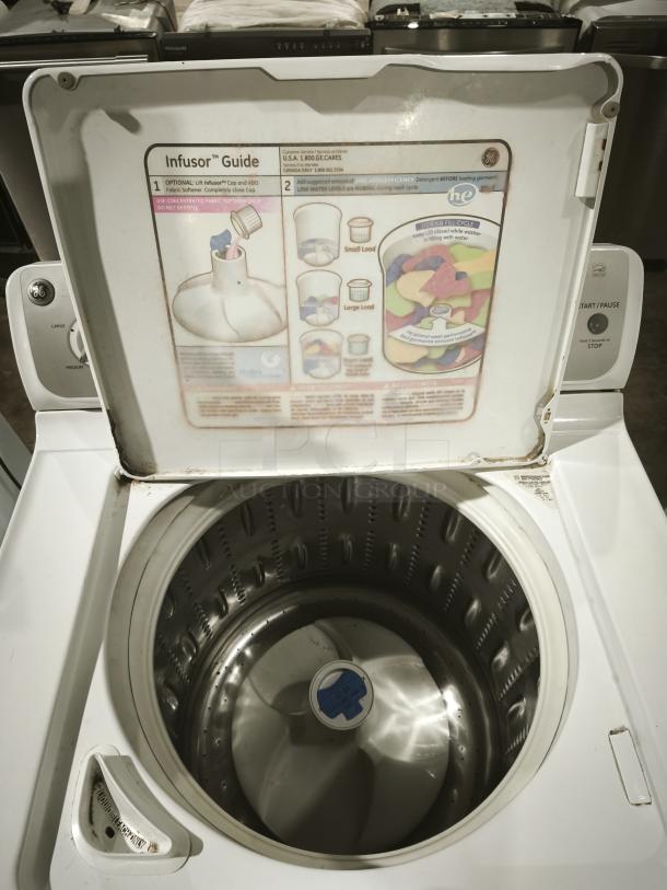 GE 4.1 cu. ft. high-efficiency top-load washer, model whre5550k2ww, white. Features infusor. Good condition. Infusor guide visible.
