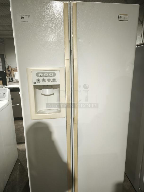 GE Eterna-series refrigerator, model ESS25LGMB, side-by-side doors, water dispenser, good condition, white finish.