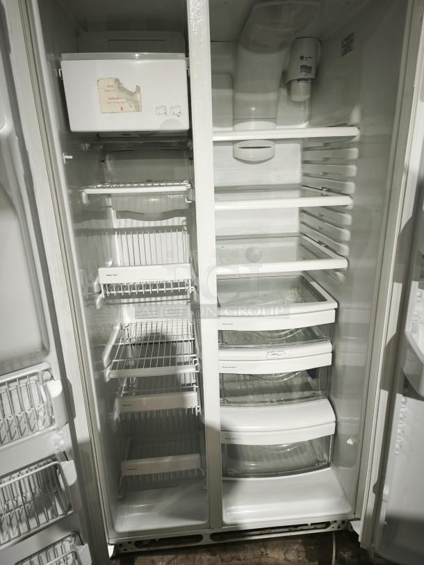 GE Eterna-series refrigerator, model ESS25LGMB, open view. Features include multiple shelves and crispers. Good condition.