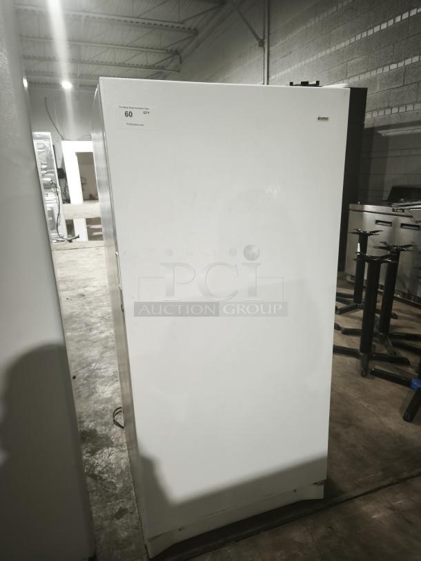 Kenmore 253.9284213 upright freezer, white, visible label, in a warehouse setting, good condition.