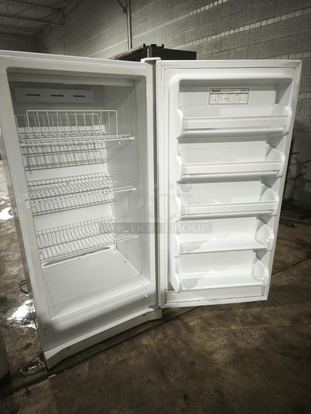 Kenmore 2539284213 upright freezer, open view, features multiple wire shelves and door storage. Clean condition with visible label.