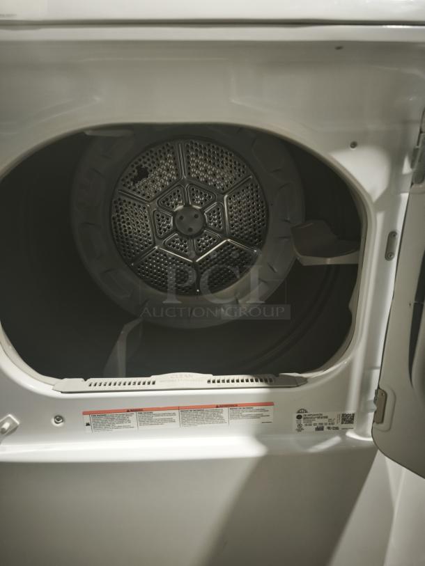 GE 7.2 cu. ft. Electric Dryer, Model GTD42EASJ2WW, white interior view, clean condition, visible instruction labels.