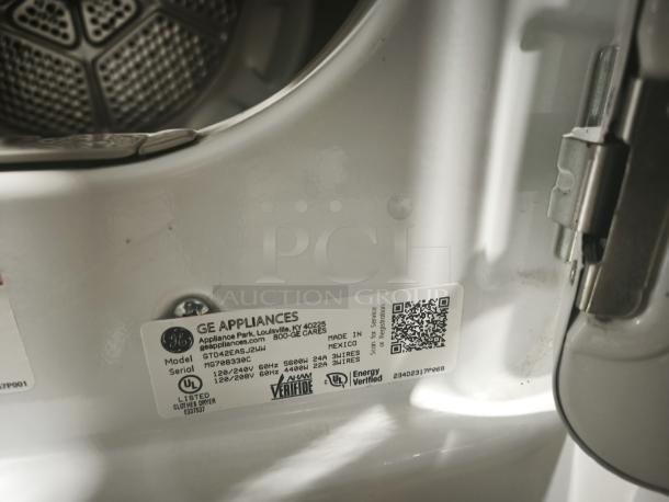 GE 7.2 cu. ft. Electric Dryer, Model GTD42EASJ2WW, showing interior and label with serial and model details.