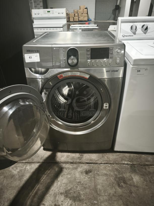 Samsung 27-inch front-load steam washer, model WF448AAP, in stainless steel. Open door, labeled VRT Steam. Good condition.
