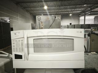 GE Profile Spacemaker® XL1800 microwave, model PVM1870DM3WW, 1.8 cu. ft., white, with control panel, in warehouse setting.