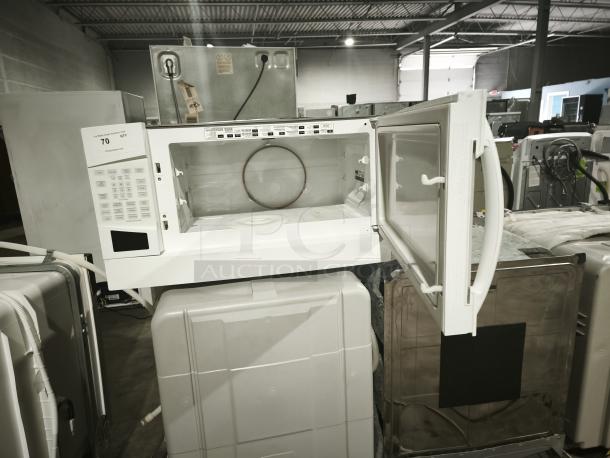 GE Profile Spacemaker 1.8 Cu. Ft. XL1800 Microwave, Model PVM1870DM3WW, featuring a white exterior and open door.