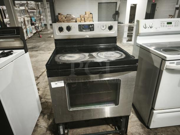 Whirlpool 30" self-cleaning freestanding electric range, model RF362LXSS. Visible wear on cooktop, label shows item 74.