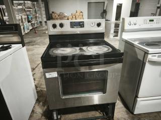 Whirlpool 30" self-cleaning freestanding electric range, model RF362LXSS. Visible wear on cooktop, label shows item 74.