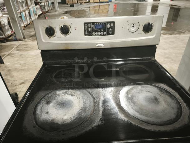 Whirlpool 30" self-cleaning freestanding electric range, model RF362LXSS. Visible wear on burners and control panel.