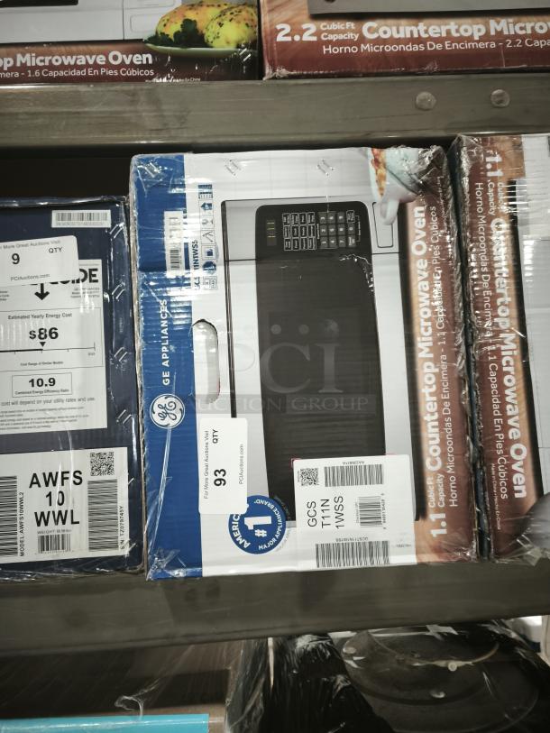 GE 1.1 cu. ft. Countertop Microwave GCST11N1WSS in box. Stainless steel finish, model label visible. New condition.