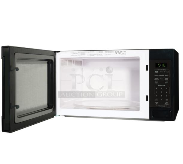 BRAND NEW GE® 1.6 Cu. Ft. Countertop Microwave Oven, Model GCST16S1WBB, black finish, 1150 watts, open door, control panel visible.