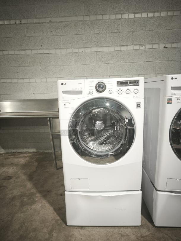 LG Steam Washer™ 3.6 cu. ft. Front-Load Model WM2650HWA, white, digital controls, visible in used condition.