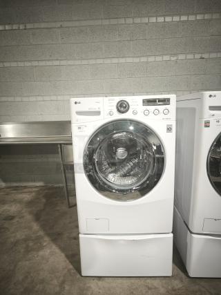 LG Steam Washer™ 3.6 cu. ft. Front-Load Model WM2650HWA, white, digital controls, visible in used condition.
