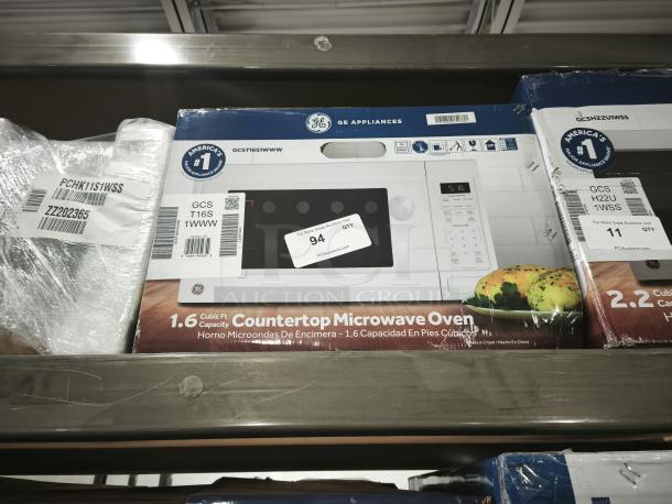 Brand new GE® 1.6 Cu. Ft. Countertop Microwave Oven, model GCST16S1WWW. Features white finish, seen in original packaging.
