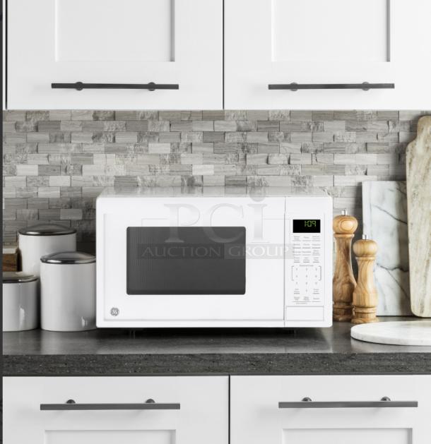 GE 0.9 Cu. Ft. countertop microwave oven, model GCST09N1WWW, in white. Features: digital display, keypad, compact size.