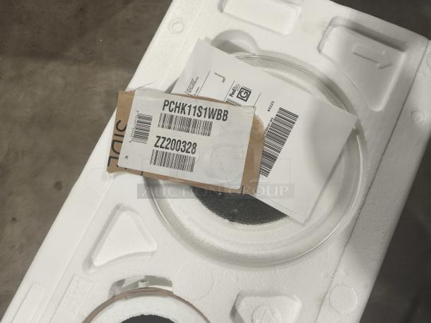 BRAND NEW SCRATCH AND DENT GE Profile Countertop Microwave Oven 1.1 Cu. Ft.; Model PCHK11S1WBB; packaging showing label.