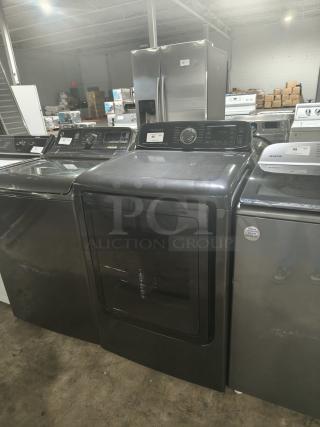 SAMSUNG 7.4 Cu. Ft. black stainless electric dryer with steam, model DVE52M7750V/A3, visible control panel and minor surface marks.