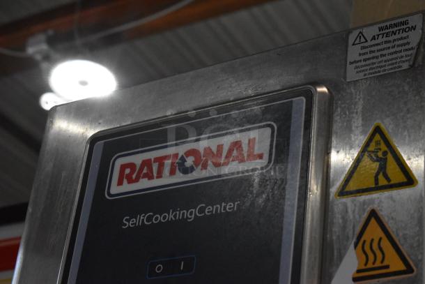 Rational SelfCookingCenter stainless steel commercial oven with safety labels. Model SCCWE62/SCCWE102.