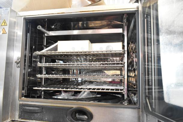 2019 Rational SCCWE62/SCCWE102 convection oven, stainless steel, electric, 480V, 3-phase, with racks, interior view.