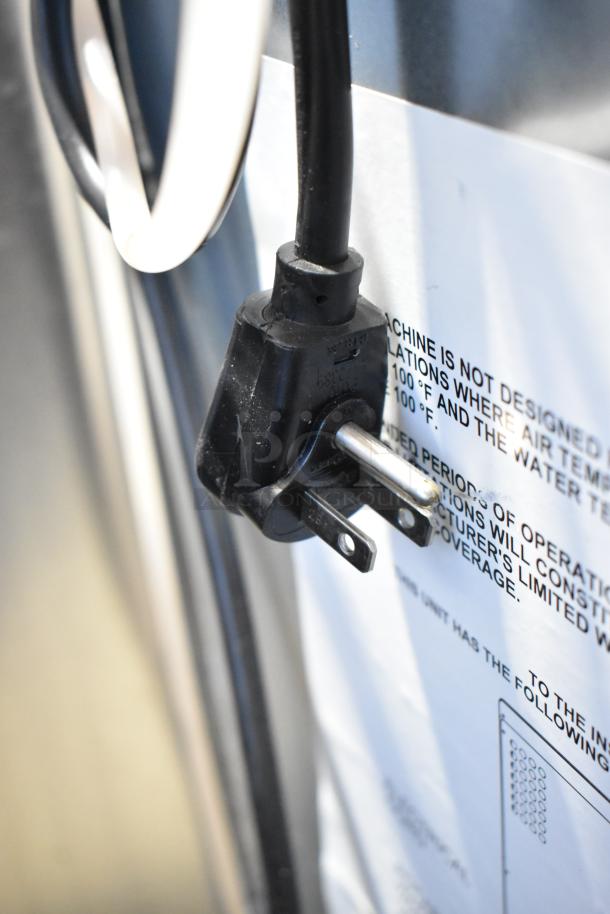 Close-up of the power plug and warning label on a 2023 Scotsman CU0415MA-1A stainless steel ice machine, 58 lb. capacity.