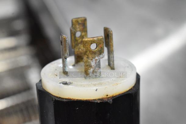 Close-up of metal prongs on a Middleby Marshall pizza oven's electrical connector, showing some wear and oxidation.