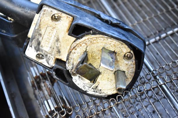 Close-up of a used electrical plug connector on a Turbochef HhC2020 oven. Features visible wear and metal details.