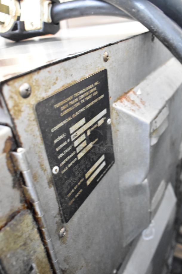 Turbochef HhC2020 label showing model and electric specs on stainless steel commercial conveyor oven.
